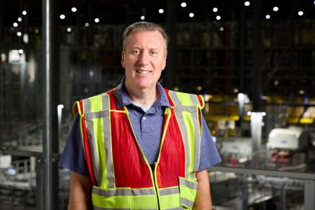 An automation project managed by Witron has halved the workforce and cut truck trips in half for a grocery wholesale operation.